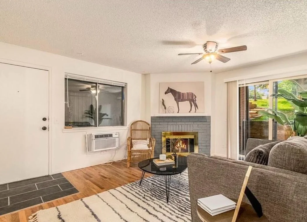 Tidy living room with fireplace after a CleanVista move-out cleaning in Denver